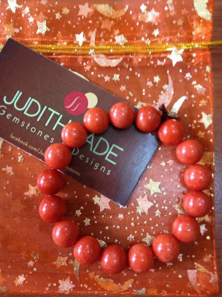 A bracelet photographed with a Judith Jade Gemstones and Designs card