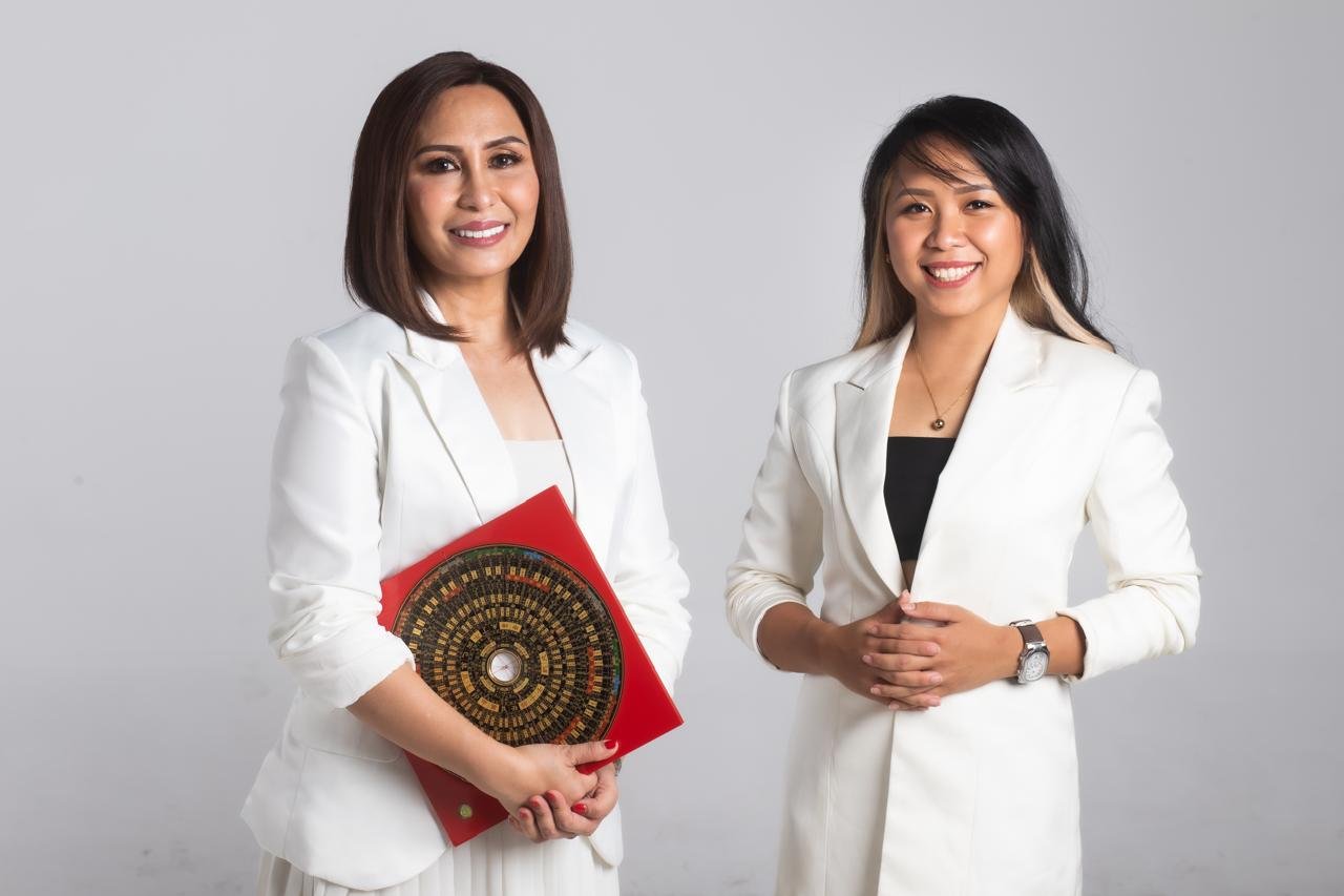 Master Judith holding a luopan beside her daughter, architect Judith Marie Eugenio